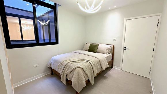 Second bedroom with a linen dressed bed