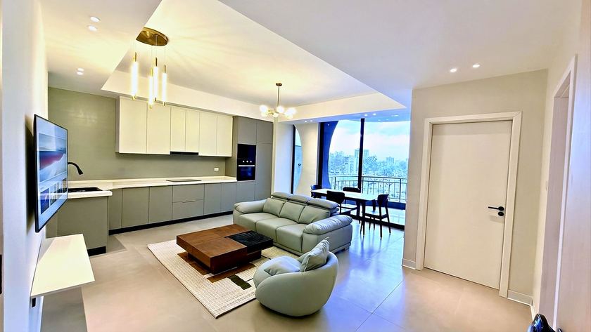 One bedroom apartment with an open kitchen, sitting area and a balcony looking over Bole